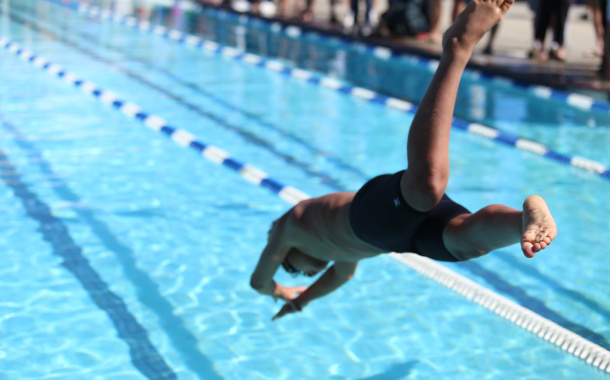 Swimmer jums into pool